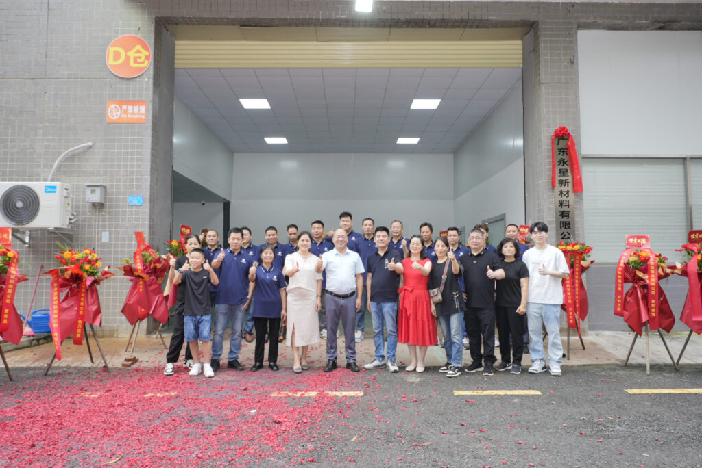 Team group photograph outside the manufacturing facility