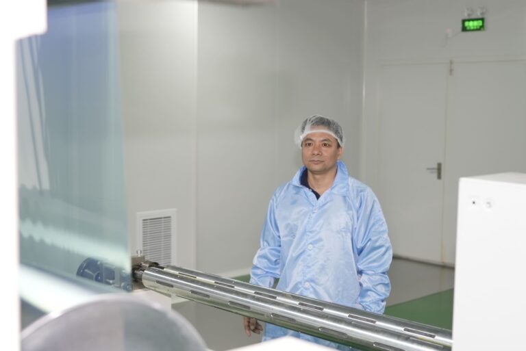 Staff member beside production equipment