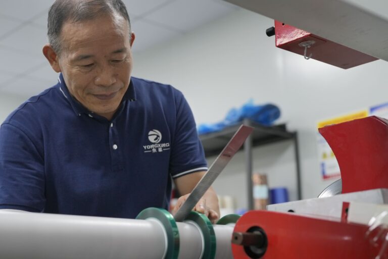 Operator working with material on a tape converting machine